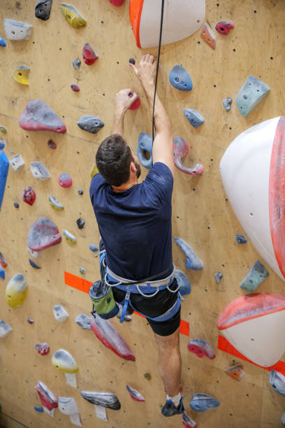istock Man Climbing Indoor Rock Wall 2178213996