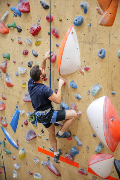 istock Man Climbing Indoor Rock Wall 2178214001