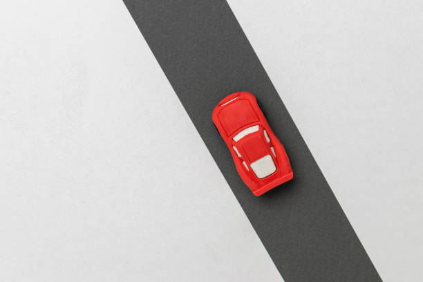 istock Minimalist Red Car on Black and White Road: Modern Transportation Concept 2178214436