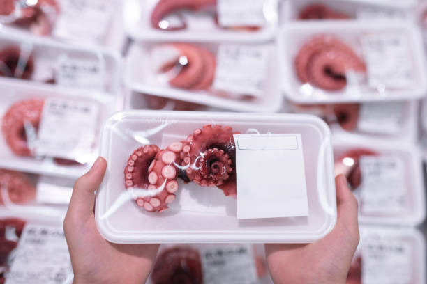 Child's hand holding a package of octopus