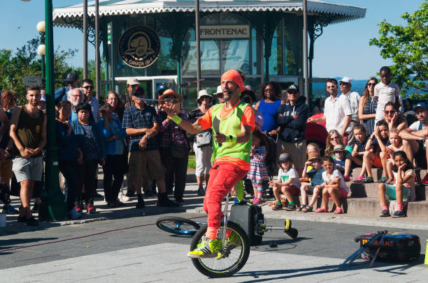 Quebec City, Canada. July 7, 2019.  A street performer juggling knives on a unicycle in old quebec city canada.