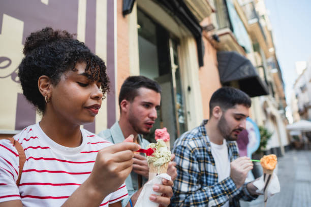 istock Group of friends enjoying ice cream while exploring city on vacation 2178216727