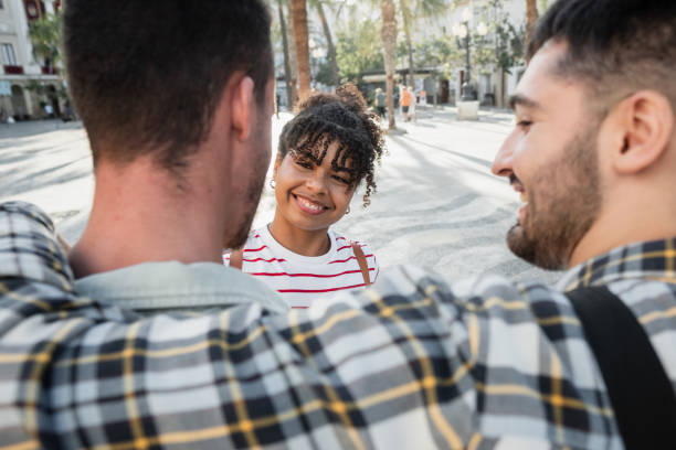 istock Three friends embracing and smiling outdoors in the city 2178216748