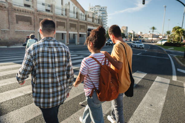 istock Two  students and blind student walking on crosswalk in urban setting 2178216754