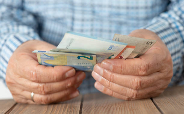 istock Senior Man Counting Money 2178217476