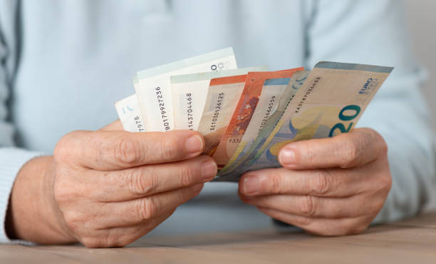 istock Senior Woman Counting Money 2178217521