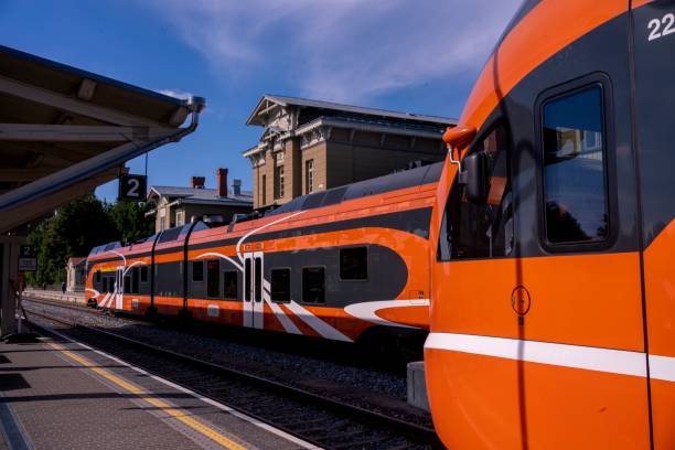 istock Modern orange train at railway station 2178218402