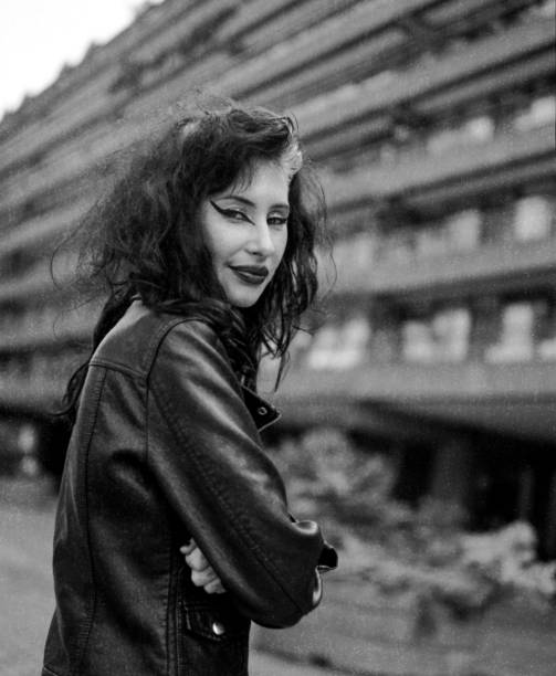 istock Smiling alternative woman looking at camera in front of building. 2178219085