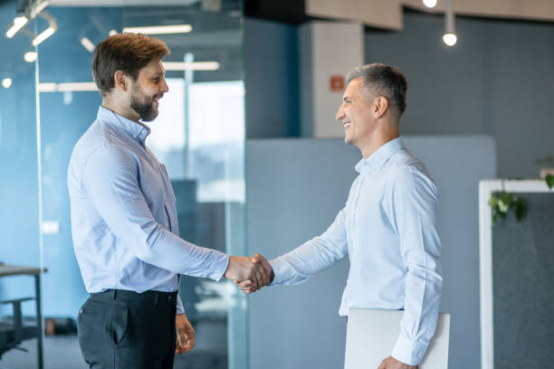 istock Professional Businessmen Shaking Hands in Office Setting 2178220236