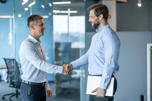 istock Two Businessmen Shaking Hands in a Modern Office 2178220242