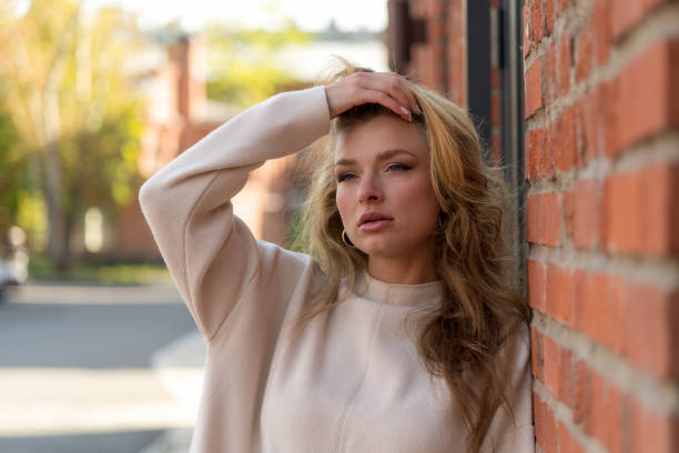 Free Stock Photo of Woman With Long Hair Standing in Front of Brick ...