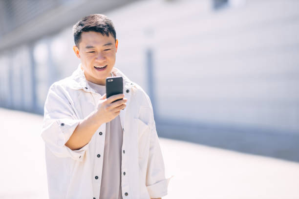istock Asian man using a digital device to talk to friends 2178222440