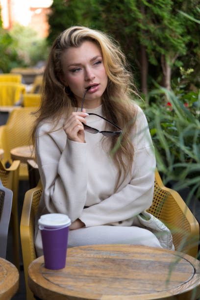 istock Serene woman in sidewalk cafe 2178224144