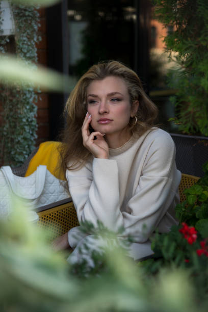 istock Beautiful woman in green sidewalk cafe 2178224633