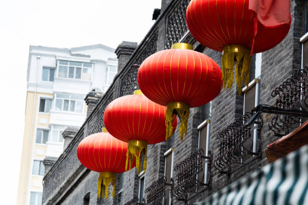 istock Red lanterns in front of brick house 2178225080