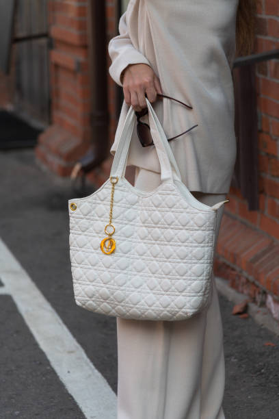 istock Woman holds handbag and sunglasses 2178226164