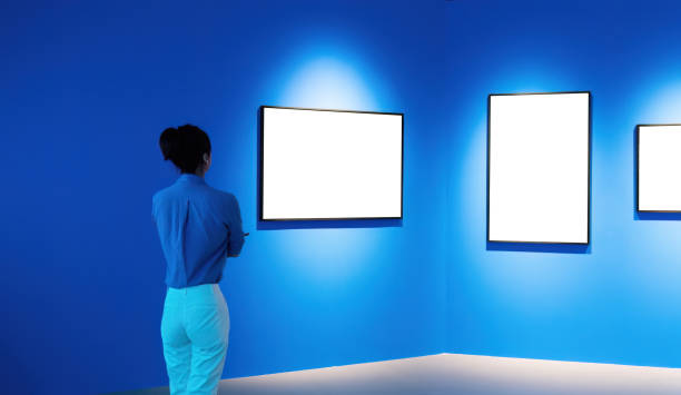 Woman standing and looking blank pictures