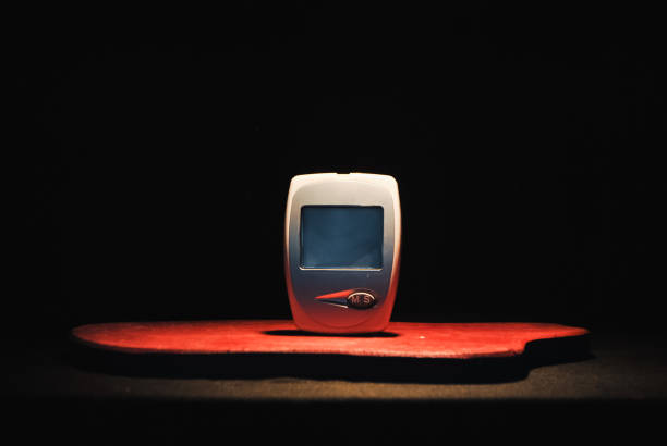 A simple glucometer sits under a spotlight as the silent guardian of health, ready to provide quick and essential blood sugar readings. This small device plays a vital role in helping individuals manage their diabetes, offering an easy way to monitor glucose levels and stay on top of their health.