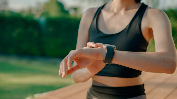 istock Young Asian woman setting a timer on her watch before starting a meditation while enjoying peace at home. 2178229992