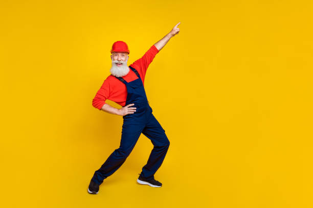 istock Full size photo of funky carefree builder long beard red headgear directing empty space hand on waist isolated on yellow color background 2178233048