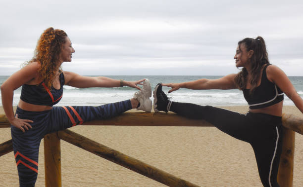 istock two girls doing sports on the beach 2178233053