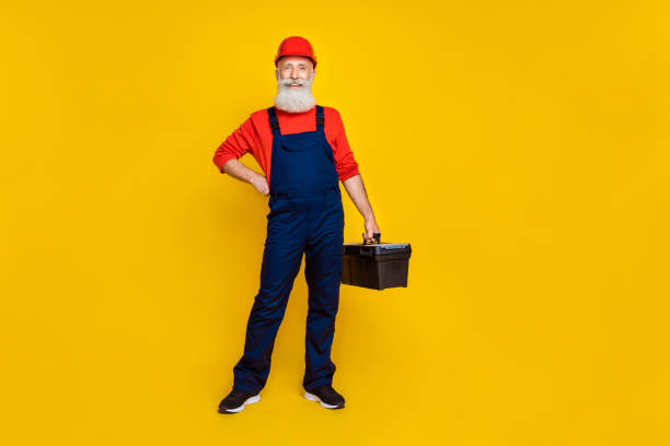 istock Full size photo of positive professional builder long beard red headgear hold tool box hand on waist isolated on yellow color background 2178233071