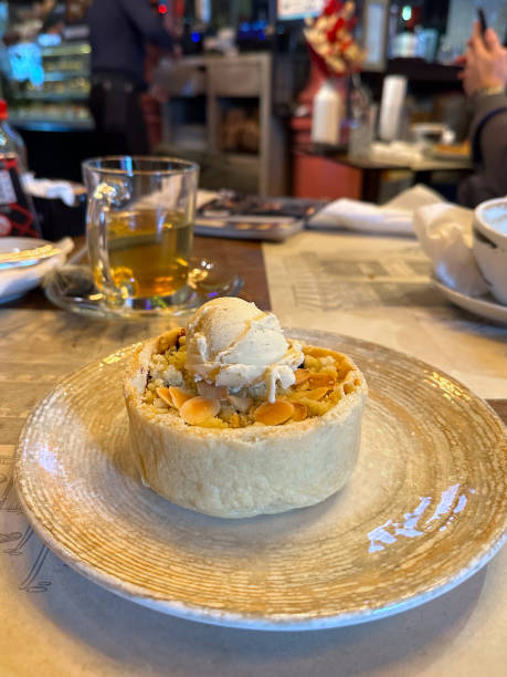 Delicious pastry topped with ice cream served in a cozy cafe, capturing the essence of delightful desserts and warm atmosphere on a casual afternoon. Sweet food