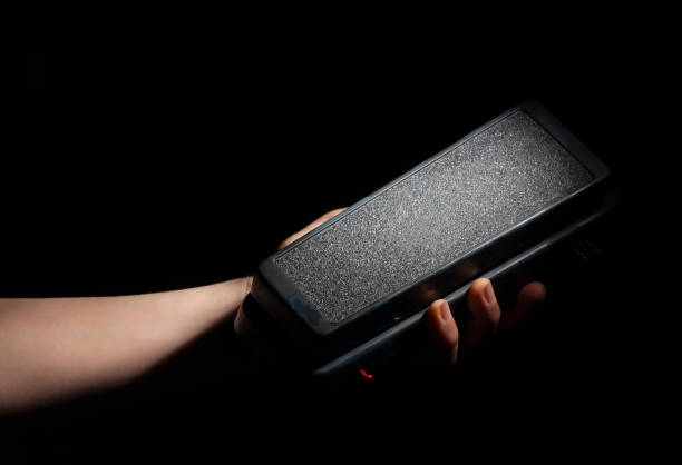 istock wah pedal in hand on black 2178235047