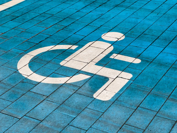 istock A designated parking spot for disabled individuals is clearly marked on the ground with a white symbol against a blue pavement surface, ensuring accessibility for all 2178235806