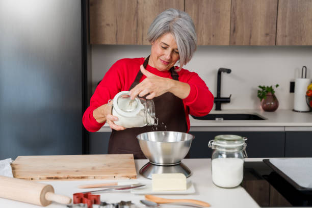 istock Woman pouring flour into bowl for christmas baking 2178236612