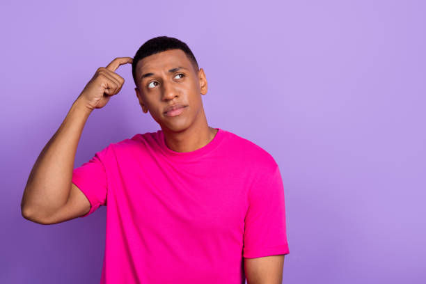 istock Portrait photo of young minded thoughtful man looking empty space scratch head advertisement unsure proposition isolated on purple color background 2178237572