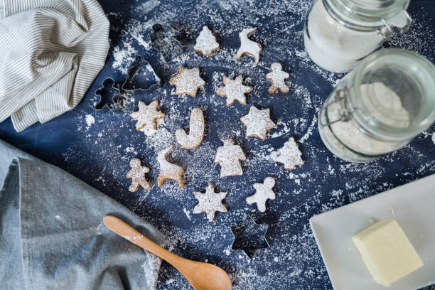 istock Christmas cookies laid out on blue table with cookie cutters 2178237605