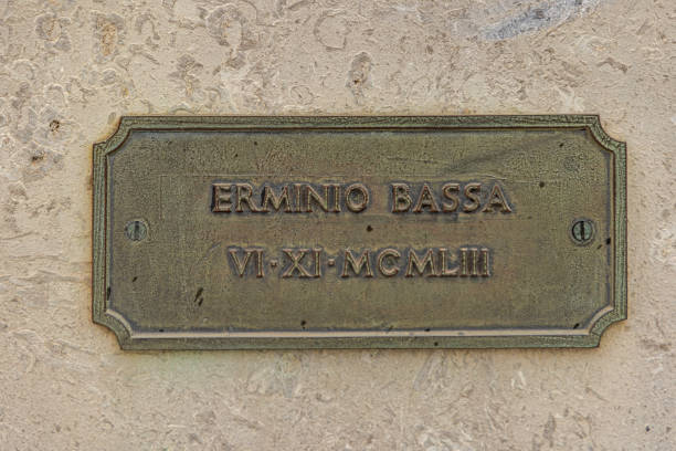 Trieste, Italy - October 08, 2024: Bronze Plaque at Monument to the Fallen Soldiers Ermino Bassa Historic Landmark at Main Square.