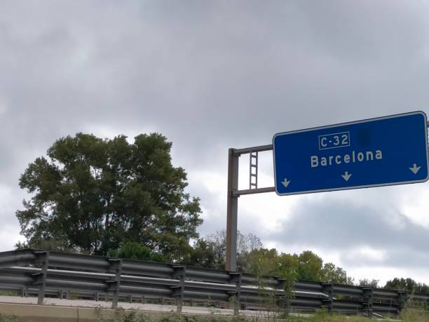 istock blue highway sign with the direction name Barcelona on a cloudy day 2178238818