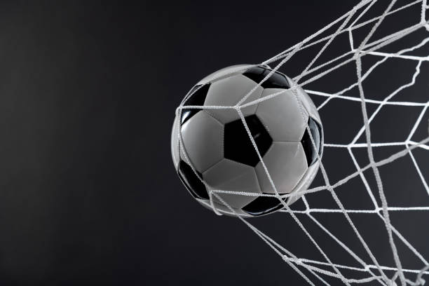 istock Soccer ball goal success on black background 2178239945