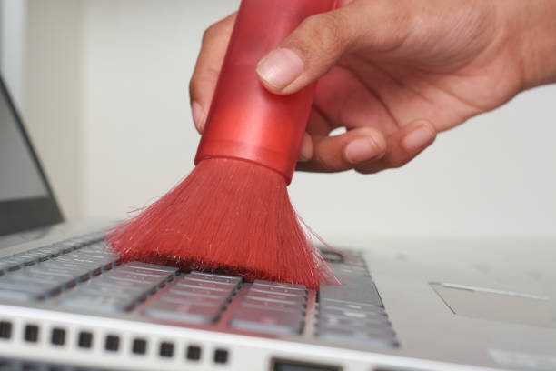 istock cleaning laptop keyboard with soft bristle brush 2178240332