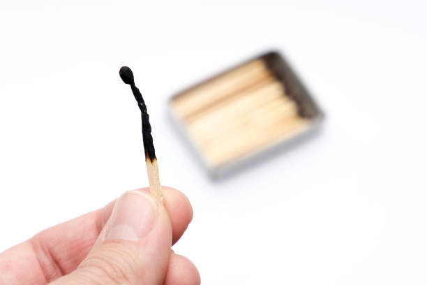 istock Hand holding burnt match stick on white background 2178240695