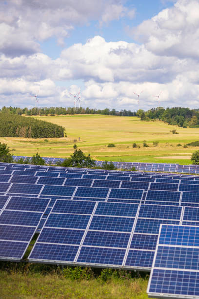 istock modern solar panels and wind turbines in a rural landscape (focus on foreground) 2178243506