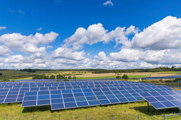 istock modern solar panels and wind turbines in a rural landscape 2178243538