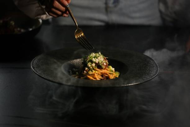 istock Gourmet pasta dish with steam rising in low light. 2178244801