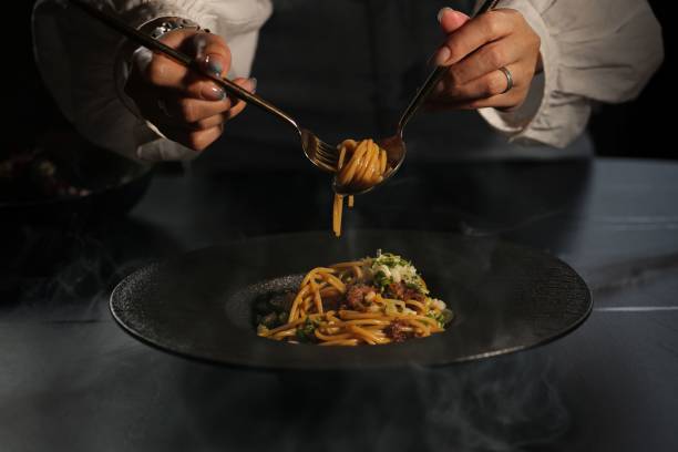 istock Twirling pasta with finesse on a dark plate. 2178244815