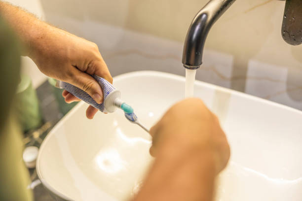 istock Man holding green toothpaste and toothbrush. 2178246324