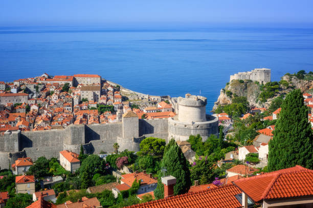 Dubrovnik medieval old town and city walls, Croatia Dubrovnik historical old town and city walls with Minceta Tower on blue Adriatic sea, Croatia fort minceta dubrovnik stock pictures, royalty-free photos & images