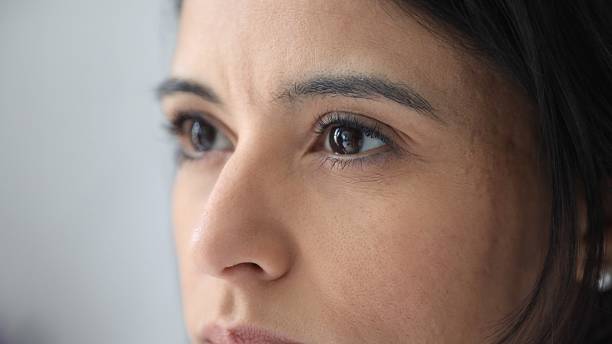 istock Young woman looking up with hope and expectation 2178246858