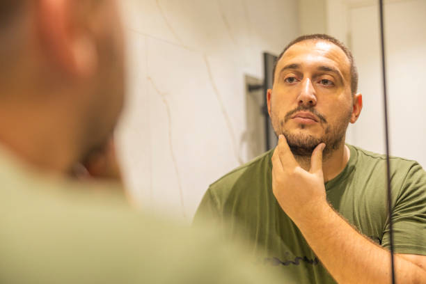 istock Men checking his beard in the bathroom before shaving. 2178248073