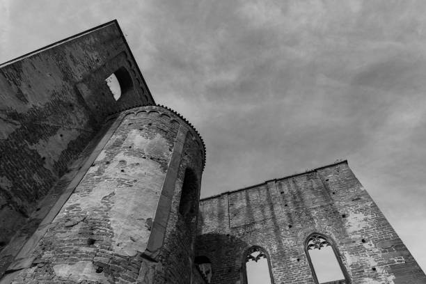 istock A weathered stone building stands tall against a cloudy sky, remnants of its past glory still visible 2178248913