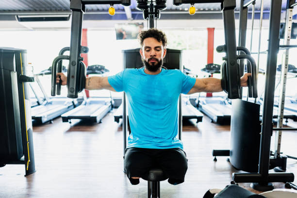 istock Mid adult man doing exercises at gym 2178253321