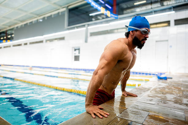 istock Mid adult man leaving swimming pool 2178253457