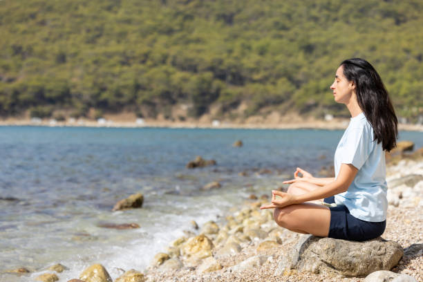 istock A woman meditating by the seaside 2178253764