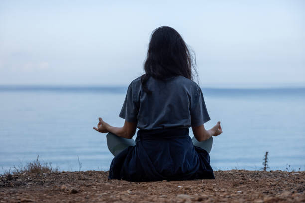 istock A woman meditating in the forest 2178254112
